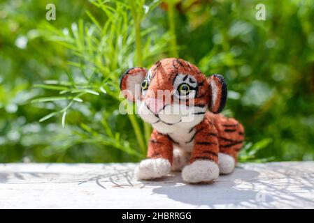 Cute funny little toy handmade woolen tiger, felting from wool Stock Photo