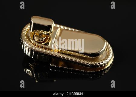 Melallic twist lock for ladies bag. Womens Twist Lock Buckle, Shoulder Bag Hardware. Decor element for a bag or a womans backpack close-up. Metal bag Stock Photo