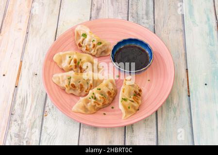 Gyoza, also known as yaki gyoza, are Japanese dumplings similar to the famous Chinese dumplings Stock Photo