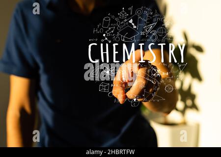 science, chemistry, people, future technology and cyberspace concept - close up scientist touching virtual chemical formula hologram Stock Photo