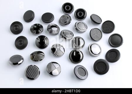 Metal button for clothes, nickel color. Sewing accessories for outerwear production. Components of the press-stud with a flat top on a white backgroun Stock Photo