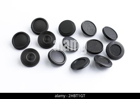 Hat buttons for clothes of a flat shape on a white background. Metallic decorative button for bags and outerwear. Sewing accessories for clothing and Stock Photo