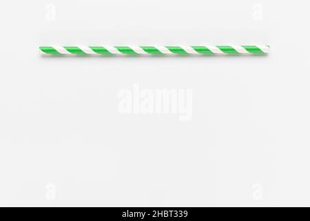 Green and white eco-friendly paper straw on white background. Recycle, environment conversation, pollution and paper recycle concept. Copy space Stock Photo