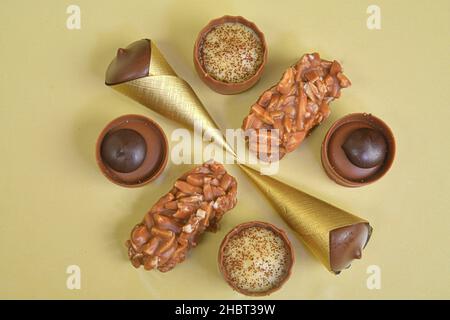 Top view of various chocolate pralines on pastel background. Top view of variety chocolate pralines. Flat lay. Mixed luxury dark and milk chocolate Stock Photo
