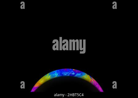 Closeup soap bubble like an planet on dark background. Abstract multicolor psychedelic planet in universe Stock Photo