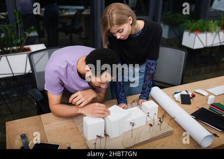 young multiethnic architects working with carton house model in office Stock Photo