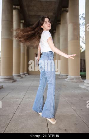 Teenage Woman Doing Jazz Dance Moves in a Loggia Stock Photo