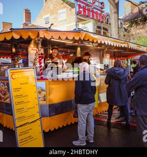 Stratford upon Avon, UK - December 12, 2021 - People queuing at a stall selling Churros at the Victorian Christmas Market. Stock Photo