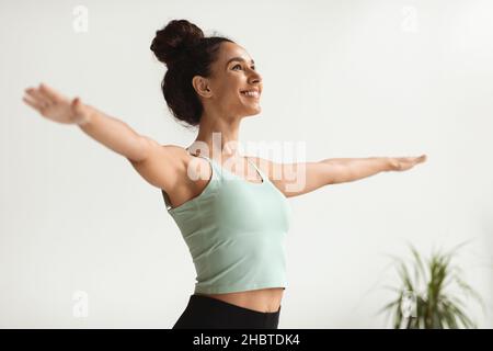 Wellbeing Concept. Portrait Of Happy Young Woman Standing With Outstretched Hands Stock Photo