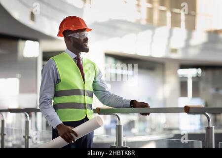 Smiling african american architect visiting building site Stock Photo