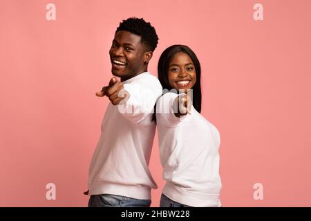 Happy african american man and woman indicating at camera Stock Photo