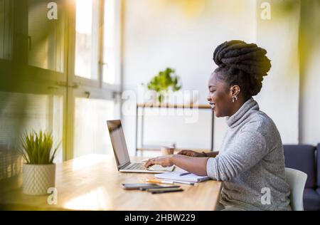 Woman working on laptop in her office Stock Photo