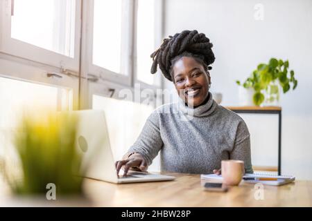 Woman working on laptop in her office Stock Photo