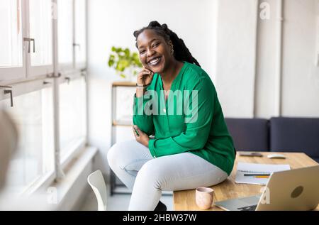 Portrait of a smiling creative woman in a modern loft office Stock Photo