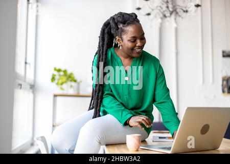 Woman working on laptop in her office Stock Photo