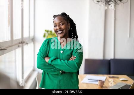 Portrait of a smiling creative woman in a modern loft office Stock Photo