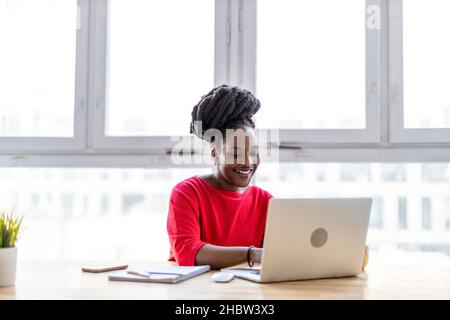 Woman working on laptop in her office Stock Photo