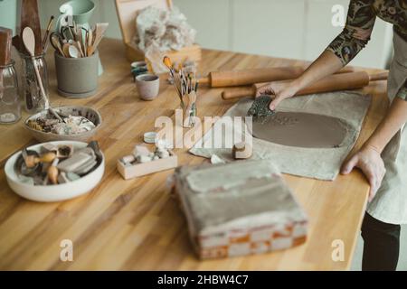 Close-up of craftswoman working on her pottery in workshop Stock Photo