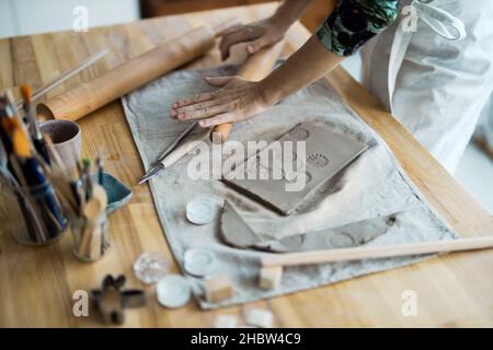 Close-up of craftswoman working on her pottery in workshop Stock Photo