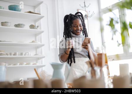 Woman pottery artist working in her art studio Stock Photo