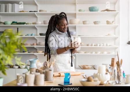Woman pottery artist working in her art studio Stock Photo