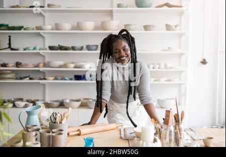 Woman pottery artist working in her art studio Stock Photo