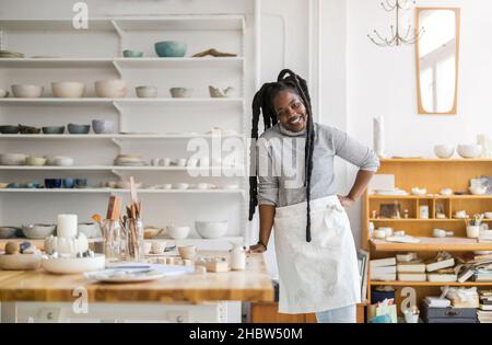Woman pottery artist working in her art studio Stock Photo