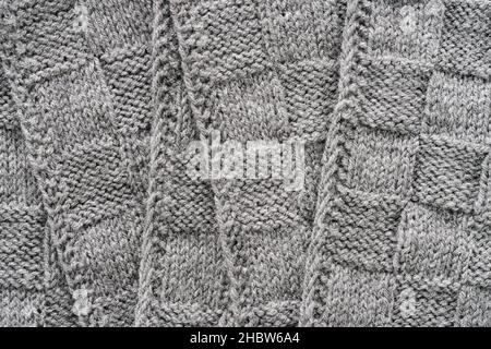 Gray knitted wool pattern texture background. Handmade Knitwear. Checkered textured background, top view Stock Photo