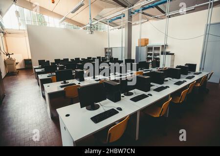 The empty computer class with modern computers on the desks in the school Stock Photo