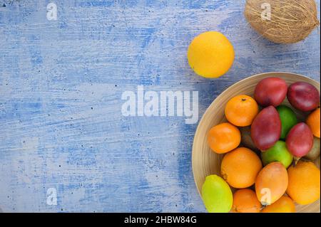 Citrus fruits on navy concrete textured. Assorted citrus fruits and tamarillo. Kiwi on vintage table and other fruits. Copy space for your text. Fruit Stock Photo