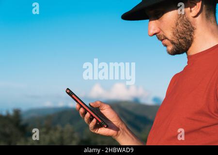 A closeup shot of a Caucasian man using his smartphone Stock Photo