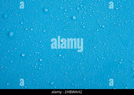 Full frame backdrop of water droplets splatter on blue background Stock Photo