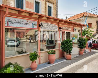 Leflimmi, Corfu, Greece - August 05, 2021: Rural taverna facade with Greek signs. Corfu is a Greek island in the Ionian Sea. Lefkimmi is the southernm