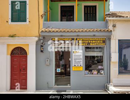 Leflimmi, Corfu, Greece - August 05, 2021: Photograph shop facade in small town. Corfu is a Greek island in the Ionian Sea. Lefkimmi is the southernmo