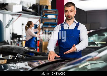 Car painter showing car after painting Stock Photo