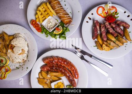 A top view of different dishes on a white table Stock Photo