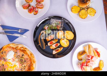 A top view of different dishes on a white table Stock Photo