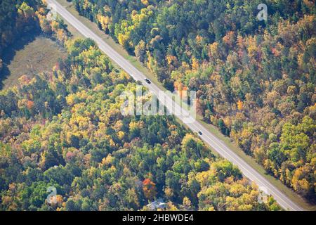 Aerial view of straight road in northern Minnesota on a sunny autumn day Stock Photo