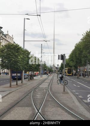 DUBLIN, IRELAND - Jul 04, 2019: The Dublin tram lines and the Spire in the background Stock Photo