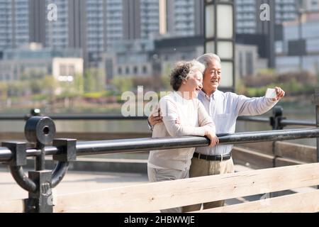 Happy old couple taking selfies with their mobile phone Stock Photo