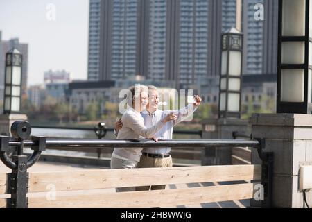 Happy old couple taking selfies with their mobile phone Stock Photo