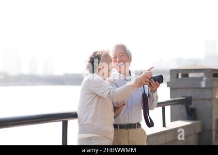 Elderly couple taking pictures with a digital camera Stock Photo