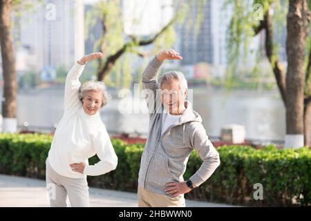 Elderly couple exercising in the park Stock Photo