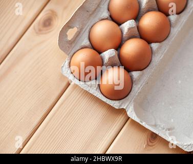 A few brown eggs among the empty cells of a large cardboard bag Stock Photo