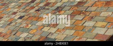 Colorful slate tile rooftop. Multi coloured roof slate tiles Stock Photo