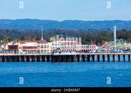 Scenic view of Santa Cruz Wharf and Beach Boardwalk Amusement Park on sunny day under clear blue sky from West Cliff - Santa Cruz, California, USA - D Stock Photo