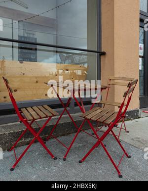 Table and empty chairs outdoor of coffee shop. Street Cafe. Wooden table with chairs. Street view, selective focus, nobody, travel photo Stock Photo