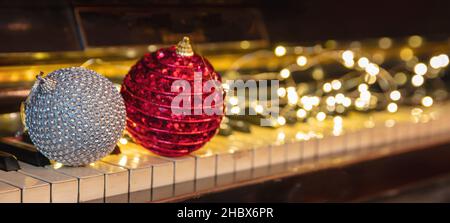 Christmas Piano music, Xmas decoration and lights bokeh background. Holiday celebration concert, party festive songs, Stock Photo