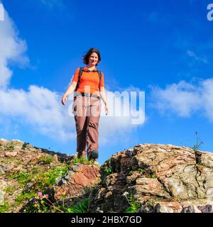 Woman hiking on mountain trail in Allgäu Alps near Oberstdorf Stock Photo