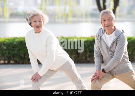 Elderly couple exercising in the park Stock Photo